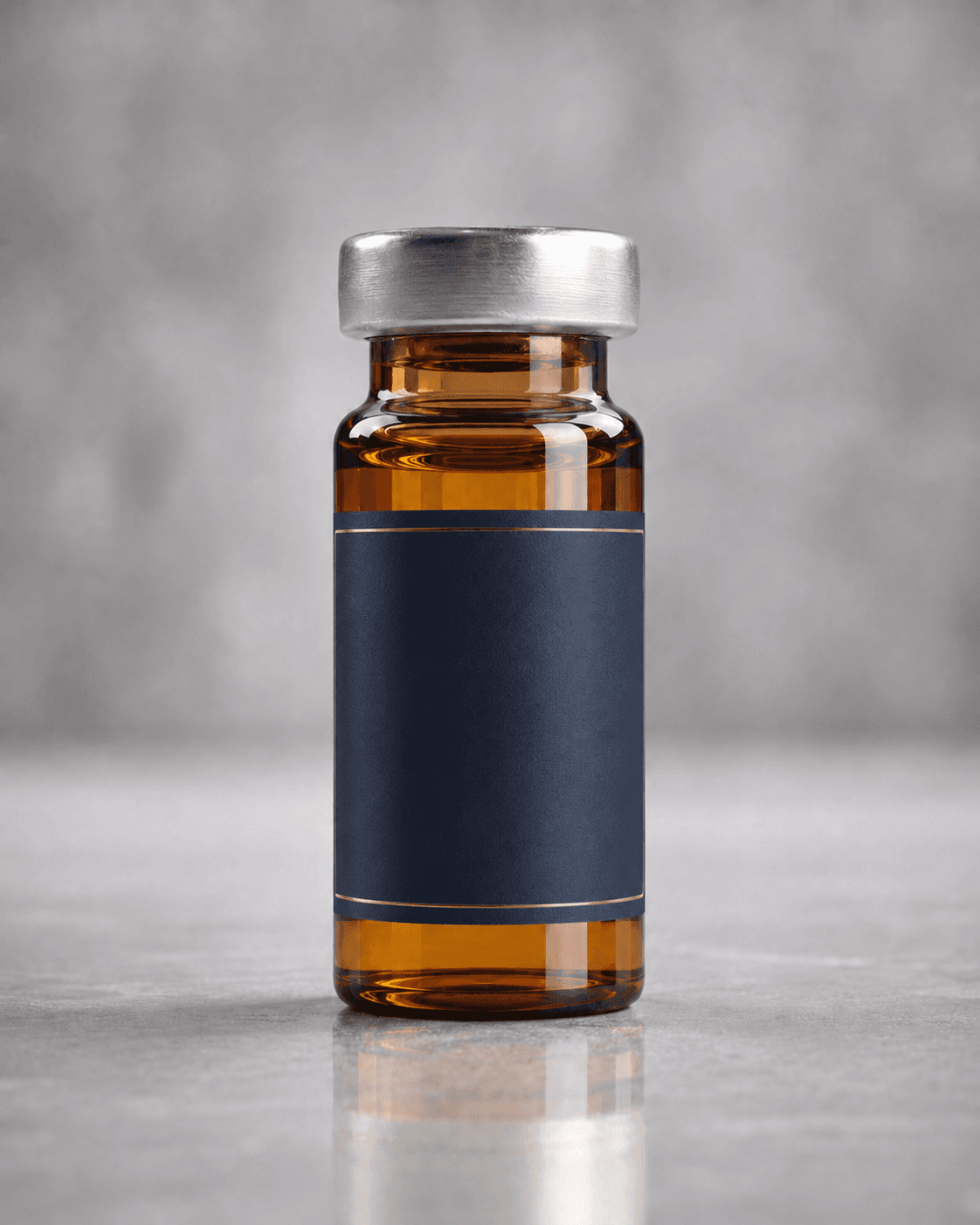 Amber compounded injectable vial with a cream label on pale stone.